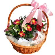 Basket with flowers, wine and rafaello