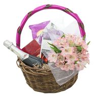 Sweets, flowers and champagne in the basket