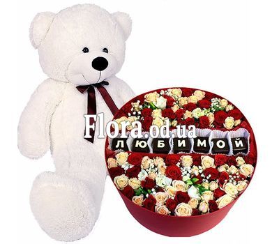 Big teddy bear and flowers in a box