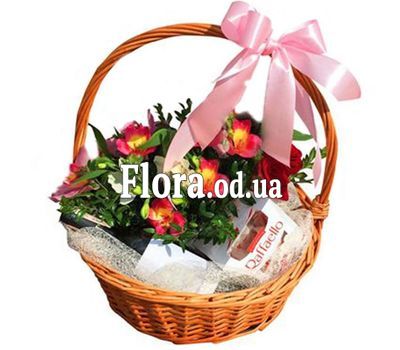 Basket with flowers, wine and rafaello